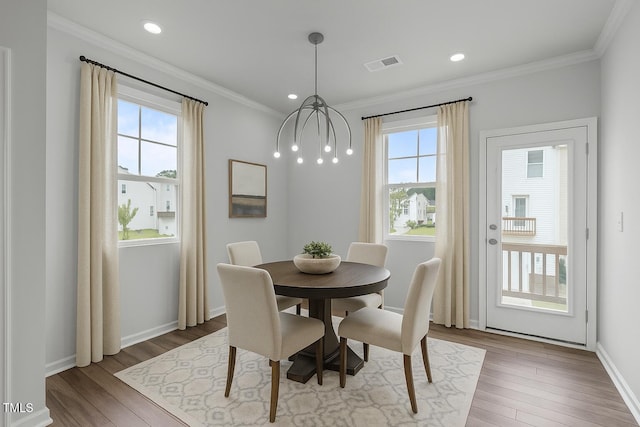 2539 Kasota Ln, Raleigh, NC 27610 - dining area featuring wood finished floors, crown molding, and recessed lighting