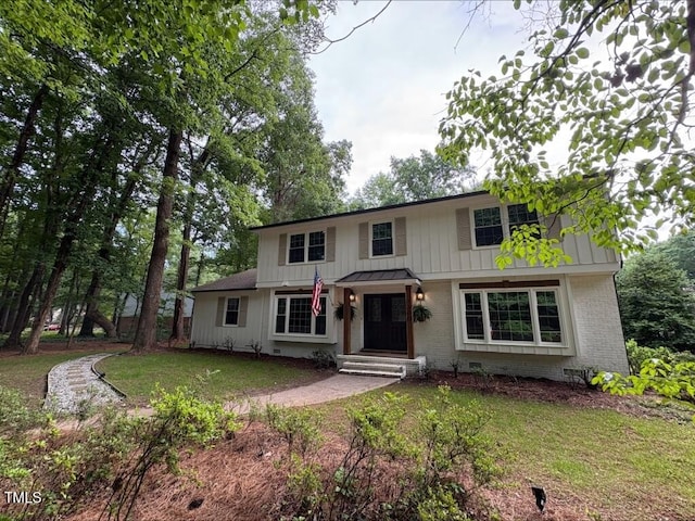 1300 Seabrook Ave, Cary, NC 27511 - traditional home featuring brick siding, a front lawn, and board and batten siding