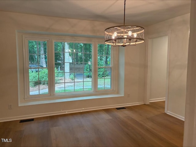 1300 Seabrook Ave, Cary, NC 27511 - unfurnished dining area with a chandelier, healthy amount of natural light, and dark wood finished floors