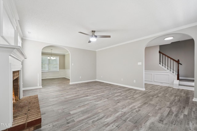 105 Leacroft Way, Durham, NC 27703 - unfurnished living room with ceiling fan, a decorative wall, a fireplace, wood finished floors, and ornamental molding