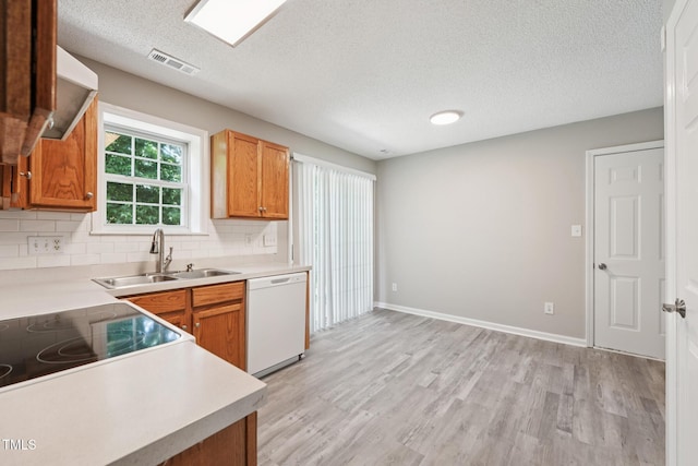 105 Leacroft Way, Durham, NC 27703 - kitchen featuring dishwasher, a textured ceiling, light wood finished floors, light countertops, and decorative backsplash