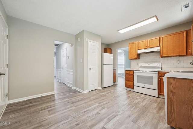 105 Leacroft Way, Durham, NC 27703 - kitchen featuring white appliances, under cabinet range hood, light wood-style flooring, and light countertops