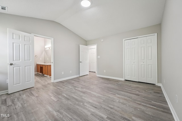 105 Leacroft Way, Durham, NC 27703 - unfurnished bedroom featuring lofted ceiling, light wood-style floors, a closet, and connected bathroom