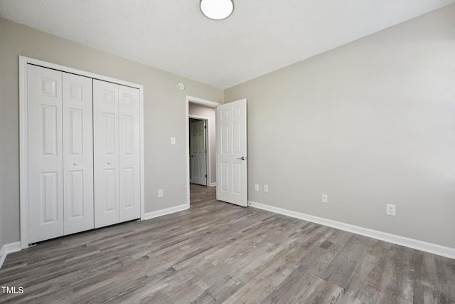 105 Leacroft Way, Durham, NC 27703 - unfurnished bedroom featuring wood finished floors and a closet