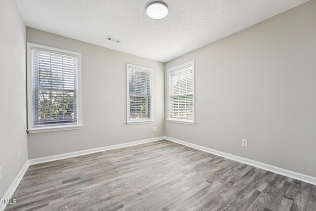 105 Leacroft Way, Durham, NC 27703 - empty room featuring wood finished floors and a textured ceiling