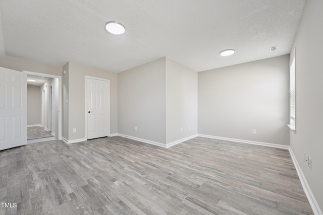 105 Leacroft Way, Durham, NC 27703 - empty room with a textured ceiling and light wood-type flooring