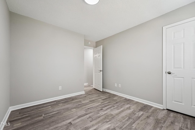 105 Leacroft Way, Durham, NC 27703 - unfurnished bedroom with wood finished floors and a textured ceiling
