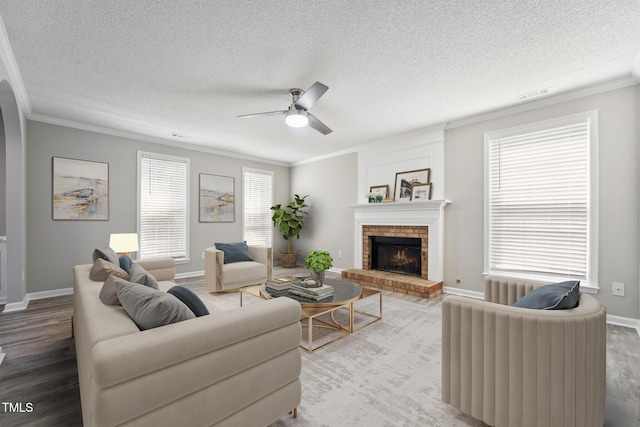 105 Leacroft Way, Durham, NC 27703 - living area featuring crown molding, wood finished floors, ceiling fan, a brick fireplace, and a textured ceiling