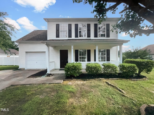 308 Quartz Dr, Durham, NC 27703 - view of front of house featuring covered porch, an attached garage, driveway, a front lawn, and roof with shingles
