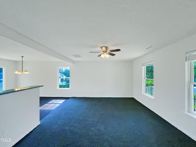 308 Quartz Dr, Durham, NC 27703 - carpeted empty room featuring healthy amount of natural light, a chandelier, and a ceiling fan
