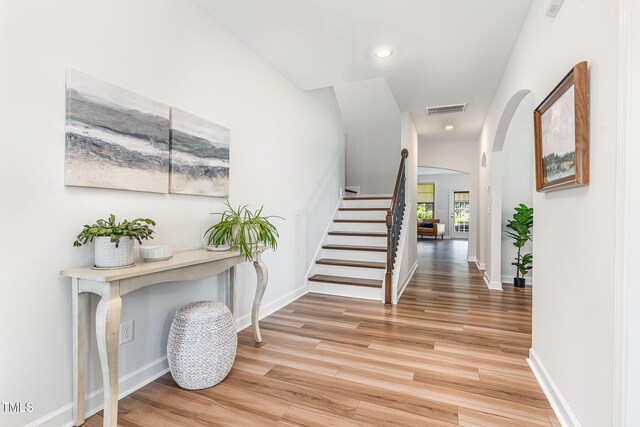 124 Airlie Place Ln, Willow Springs, NC 27592 - hallway with arched walkways, light wood-type flooring, stairs, and recessed lighting