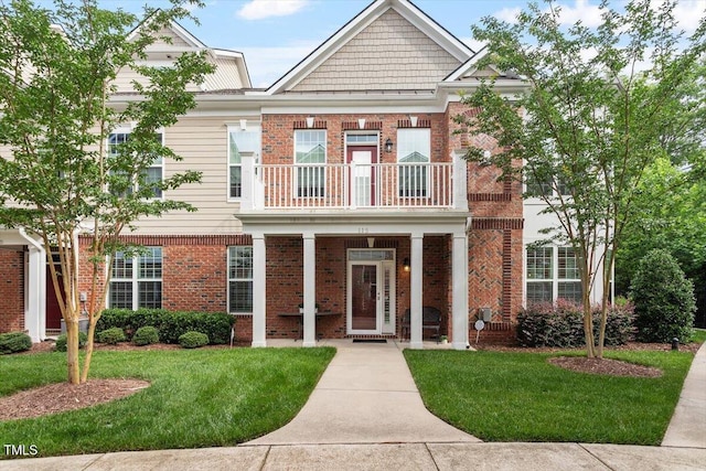 10310 Sablewood Dr Unit 115, Raleigh, NC 27617 - view of front of house featuring a balcony, brick siding, and a front lawn