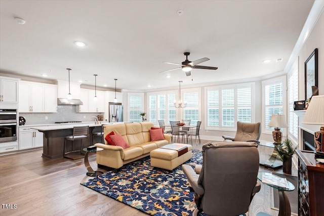 10310 Sablewood Dr Unit 115, Raleigh, NC 27617 - living area featuring ceiling fan, wood finished floors, recessed lighting, crown molding, and a chandelier