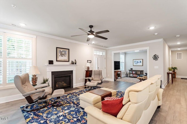 10310 Sablewood Dr Unit 115, Raleigh, NC 27617 - living area with light wood finished floors, a fireplace with flush hearth, ceiling fan, recessed lighting, and ornamental molding