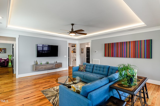 405 Culvert St, Apex, NC 27502 - living room with a tray ceiling, a ceiling fan, and wood finished floors