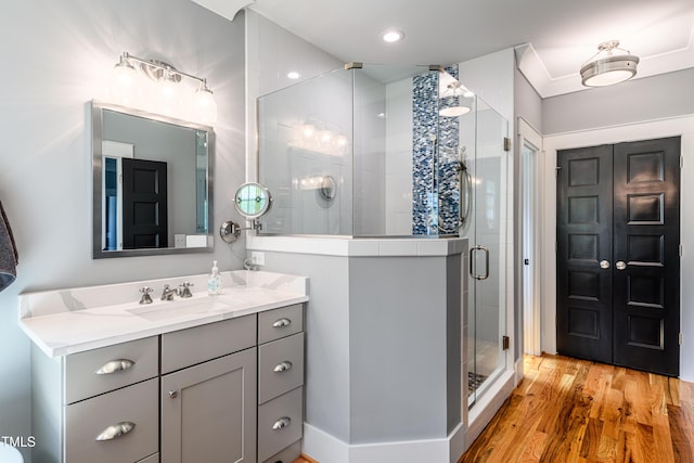 405 Culvert St, Apex, NC 27502 - full bathroom featuring vanity, a stall shower, wood finished floors, and recessed lighting
