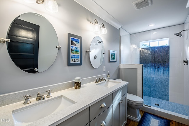405 Culvert St, Apex, NC 27502 - bathroom featuring tiled shower, double vanity, recessed lighting, and wood finished floors