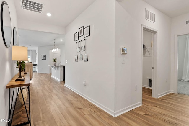 265 Purple Aster St, Youngsville, NC 27596 - hallway featuring light wood-style flooring, recessed lighting, and a chandelier