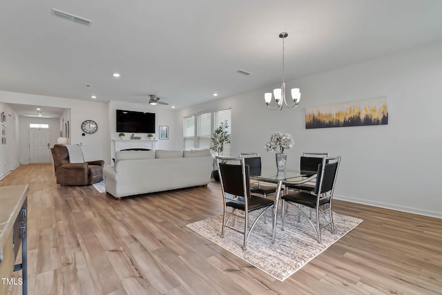 265 Purple Aster St, Youngsville, NC 27596 - dining area with light wood-type flooring, recessed lighting, a chandelier, and ceiling fan