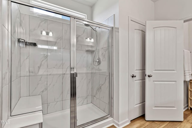 265 Purple Aster St, Youngsville, NC 27596 - bathroom featuring a marble finish shower and wood finished floors