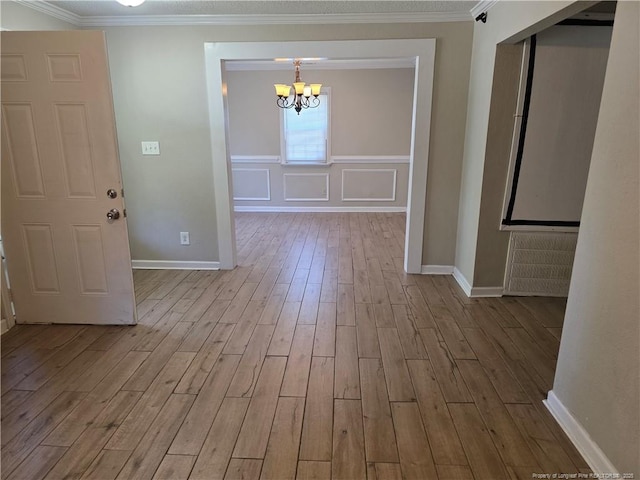 4969 Arlington St, Hope Mills, NC 28348 - hall with a chandelier, wood finished floors, and ornamental molding