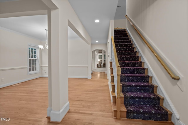 1040 Bellenden Dr, Durham, NC 27713 - stairs featuring arched walkways, wood finished floors, ornamental molding, healthy amount of natural light, and recessed lighting