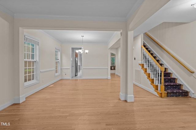 1040 Bellenden Dr, Durham, NC 27713 - entrance foyer with a chandelier, light wood finished floors, stairs, and crown molding