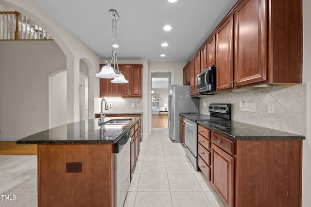 1040 Bellenden Dr, Durham, NC 27713 - kitchen featuring stainless steel appliances, arched walkways, light tile patterned floors, recessed lighting, and tasteful backsplash