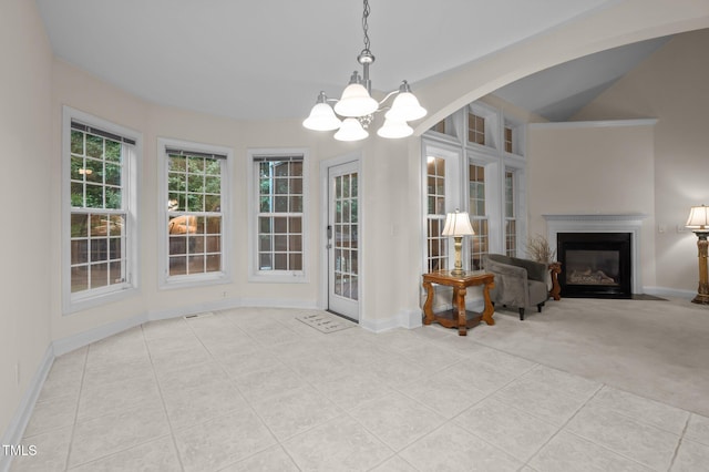 1040 Bellenden Dr, Durham, NC 27713 - unfurnished dining area featuring a chandelier, a fireplace with flush hearth, tile patterned floors, and carpet floors