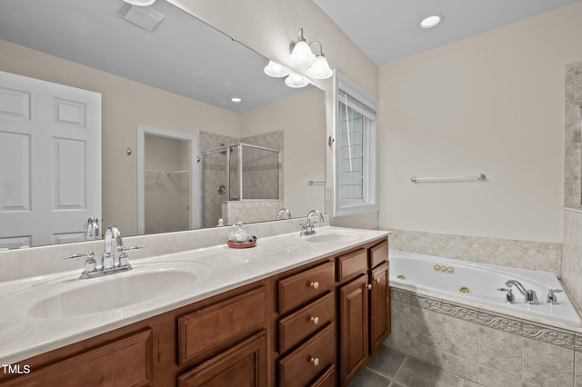 1040 Bellenden Dr, Durham, NC 27713 - full bath featuring a stall shower, a jetted tub, double vanity, tile patterned flooring, and a spacious closet