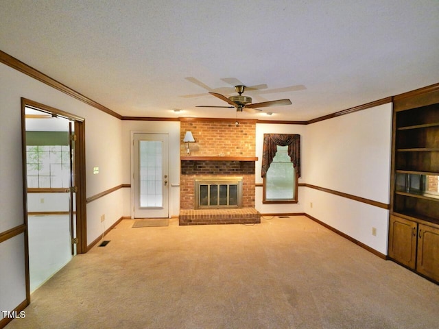 637 Shadywood Ln, Raleigh, NC 27603 - unfurnished living room featuring ceiling fan, light carpet, ornamental molding, and a brick fireplace
