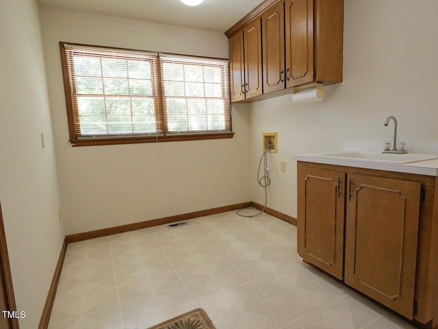 637 Shadywood Ln, Raleigh, NC 27603 - laundry room featuring hookup for a washing machine, light flooring, and cabinet space