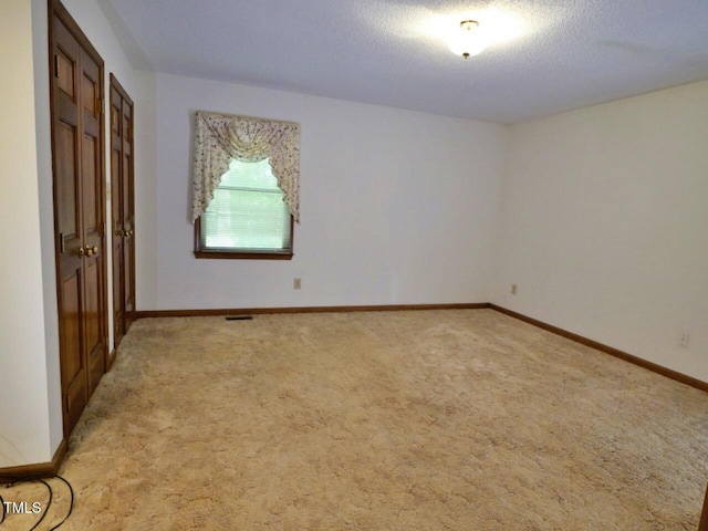 637 Shadywood Ln, Raleigh, NC 27603 - unfurnished bedroom featuring light carpet and a textured ceiling