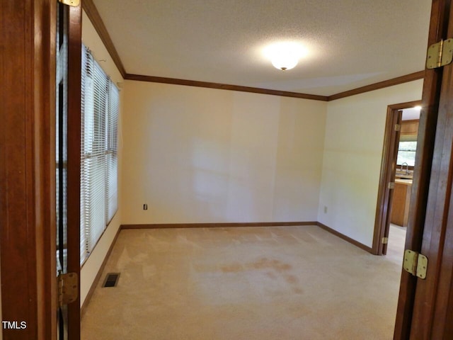 637 Shadywood Ln, Raleigh, NC 27603 - empty room featuring light carpet, crown molding, and a textured ceiling