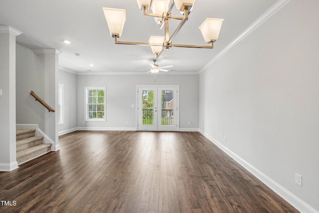 549 Forestville Rd, Wake Forest, NC 27587 - spare room with dark wood-style floors, stairs, ornamental molding, ceiling fan, and a chandelier