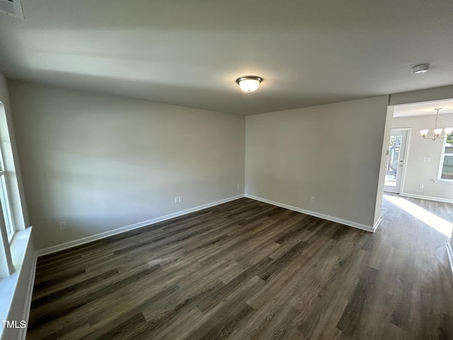 201 W Railroad St, Robersonville, NC 27871 - spare room with dark wood finished floors, a chandelier, and a smoke detector