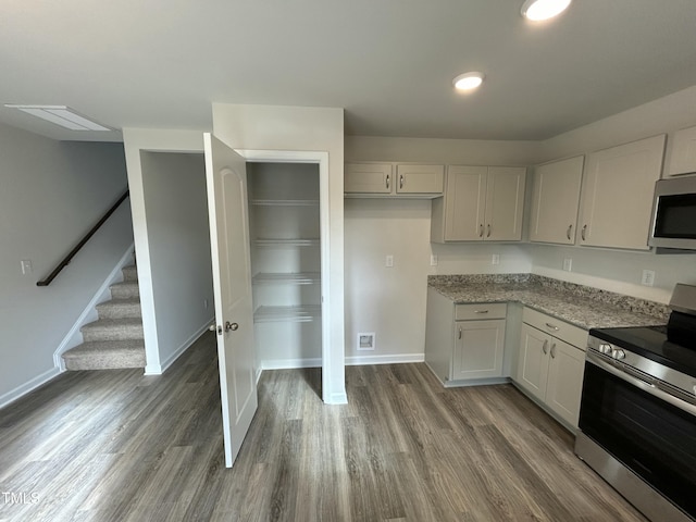 201 W Railroad St, Robersonville, NC 27871 - kitchen with stainless steel appliances, white cabinets, wood finished floors, light stone counters, and recessed lighting