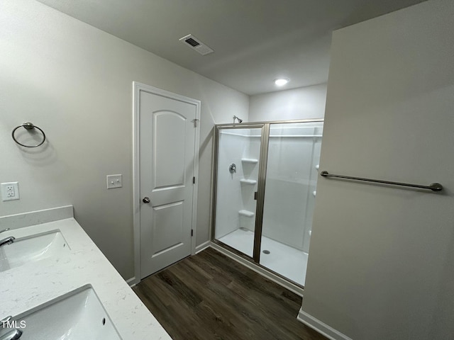 201 W Railroad St, Robersonville, NC 27871 - bathroom with wood finished floors, a shower stall, and double vanity