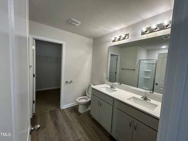 201 W Railroad St, Robersonville, NC 27871 - bathroom featuring wood finished floors, a shower with door, double vanity, and a spacious closet