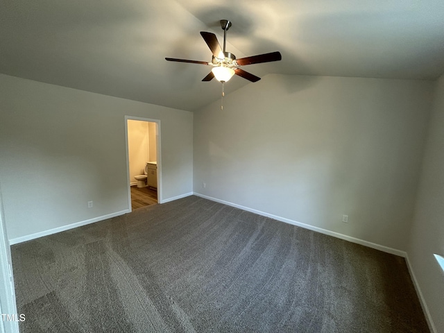 201 W Railroad St, Robersonville, NC 27871 - unfurnished bedroom with dark colored carpet, lofted ceiling, connected bathroom, and ceiling fan