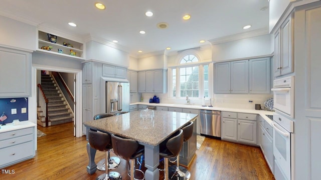 604 Hillcrest Pl, Goldsboro, NC 27534 - kitchen with appliances with stainless steel finishes, crown molding, a breakfast bar area, recessed lighting, and light wood-type flooring