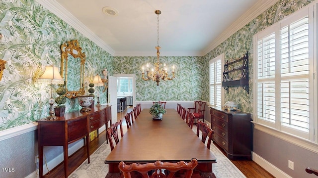 604 Hillcrest Pl, Goldsboro, NC 27534 - dining area with wallpapered walls, a chandelier, healthy amount of natural light, wood finished floors, and ornamental molding