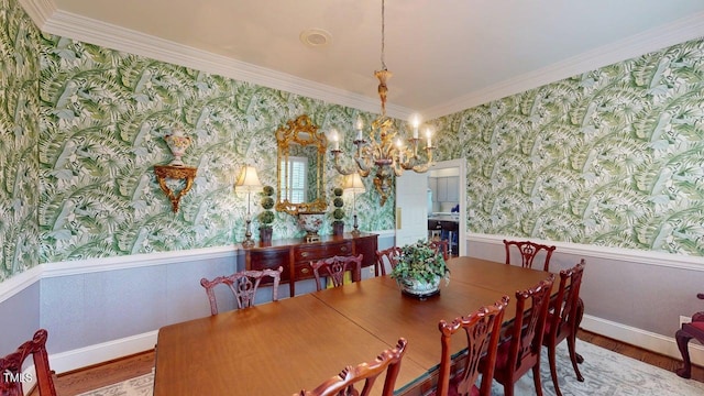 604 Hillcrest Pl, Goldsboro, NC 27534 - dining area with wallpapered walls, wood finished floors, a wainscoted wall, a chandelier, and crown molding