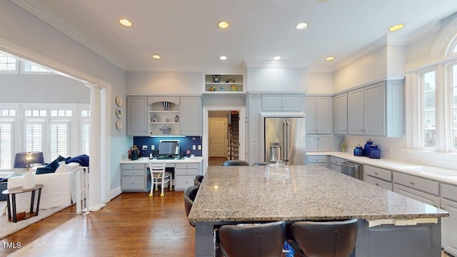 604 Hillcrest Pl, Goldsboro, NC 27534 - kitchen with high end refrigerator, gray cabinets, open shelves, a center island, and built in desk