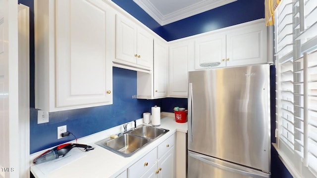 604 Hillcrest Pl, Goldsboro, NC 27534 - kitchen with freestanding refrigerator, ornamental molding, light countertops, and white cabinets