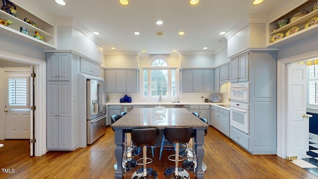 604 Hillcrest Pl, Goldsboro, NC 27534 - kitchen with stainless steel appliances, open shelves, light wood-style flooring, a kitchen island, and recessed lighting