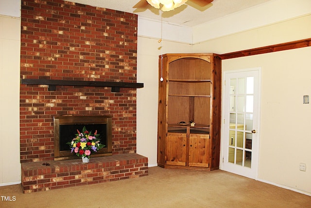 2071 Meadow Ln, Graham, NC 27253 - unfurnished living room featuring a ceiling fan, carpet floors, and a brick fireplace