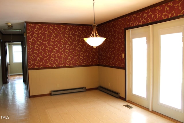 2071 Meadow Ln, Graham, NC 27253 - unfurnished dining area featuring wainscoting, a baseboard radiator, wallpapered walls, light flooring, and attic access