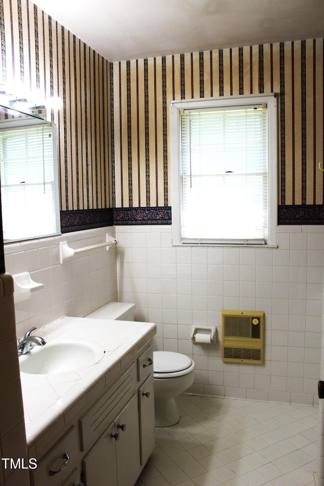 2071 Meadow Ln, Graham, NC 27253 - half bathroom with wallpapered walls, heating unit, vanity, healthy amount of natural light, and wainscoting