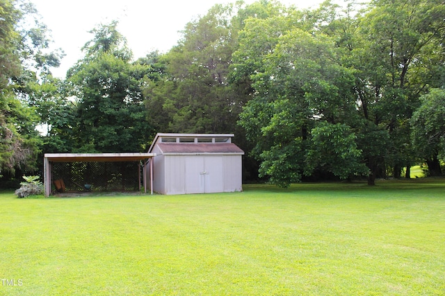 2071 Meadow Ln, Graham, NC 27253 - view of green lawn with a storage shed, a carport, and view of scattered trees